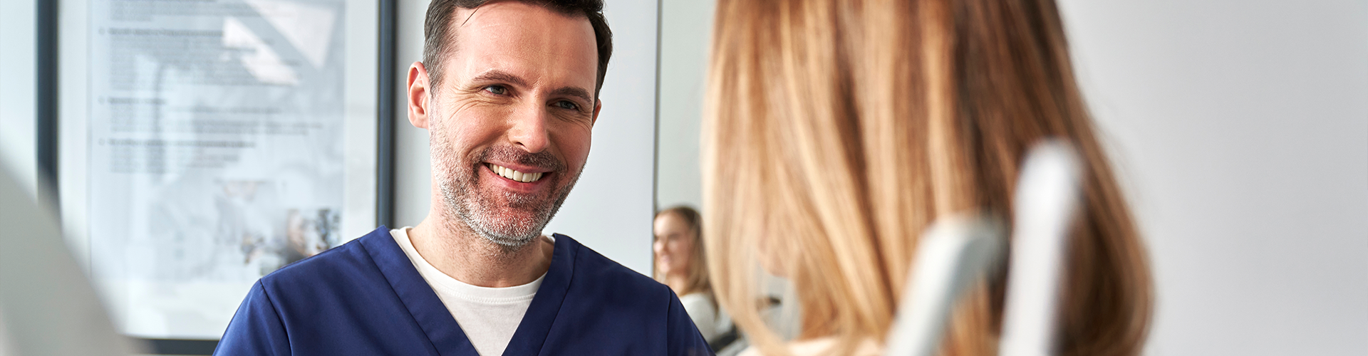dentist smiling at patient.